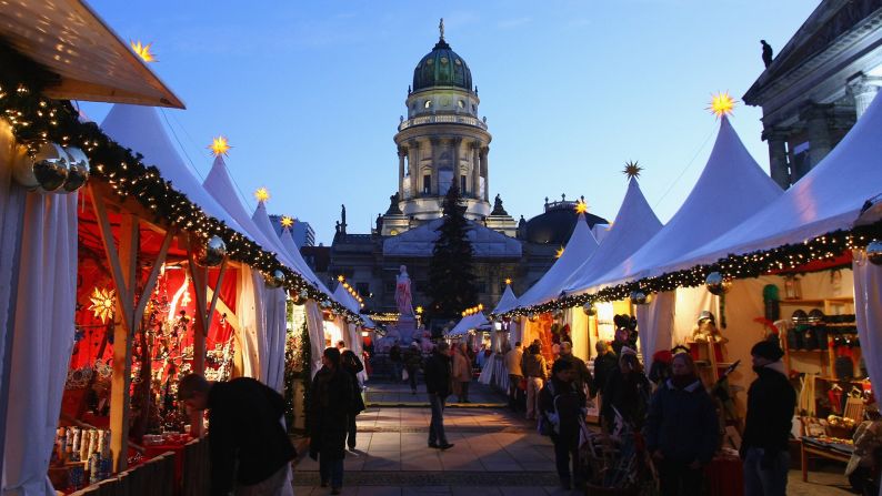 <strong>December in Germany:</strong> People walk through the annual Christmas market at Gendarmenmarkt square in Berlin.