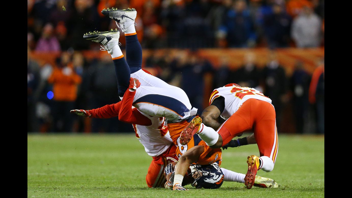 Denver tight end A.J. Derby, center, is tackled by two Kansas City Chiefs during an NFL game in Denver on Sunday, November 27.