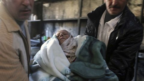 An elderly person is carried out of rebel-held eastern Aleppo in this photo from the Rumaf Syrian-Kurdish activist group.