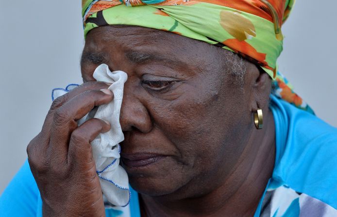 A woman dries her tears as she waits to pay her respects in Havana on November 28.