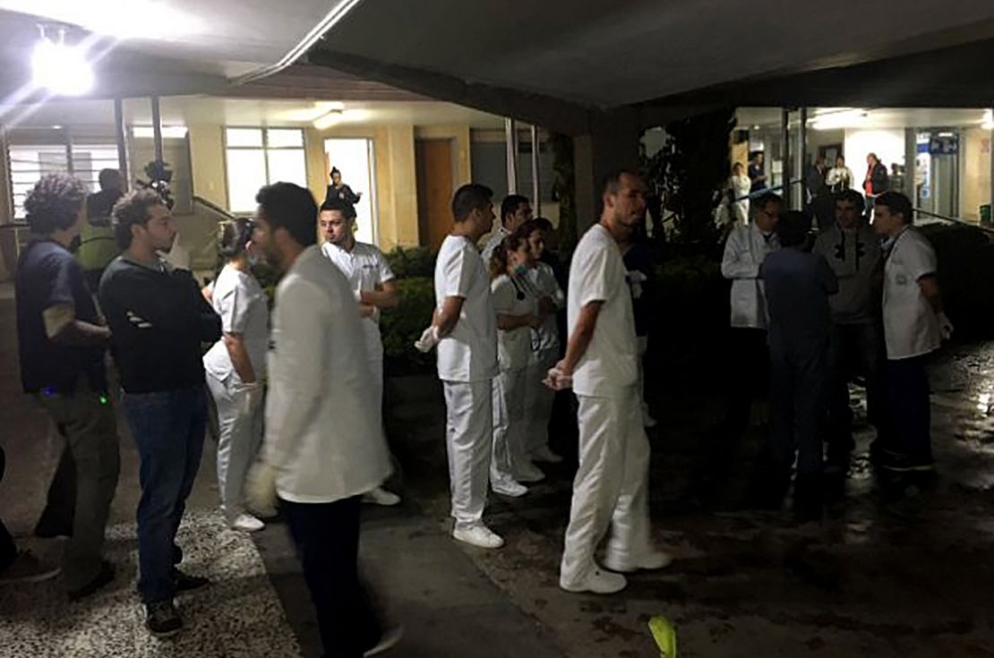 Medical staff members wait for survivors of the plane crash Tuesday at a hospital near Medellin.