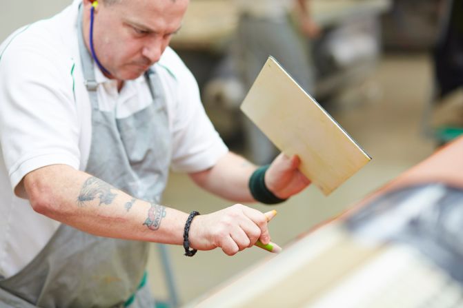 The team of leather inspectors gets through around 70,000 hides per year, flagging up areas for the cutting machines to avoid.