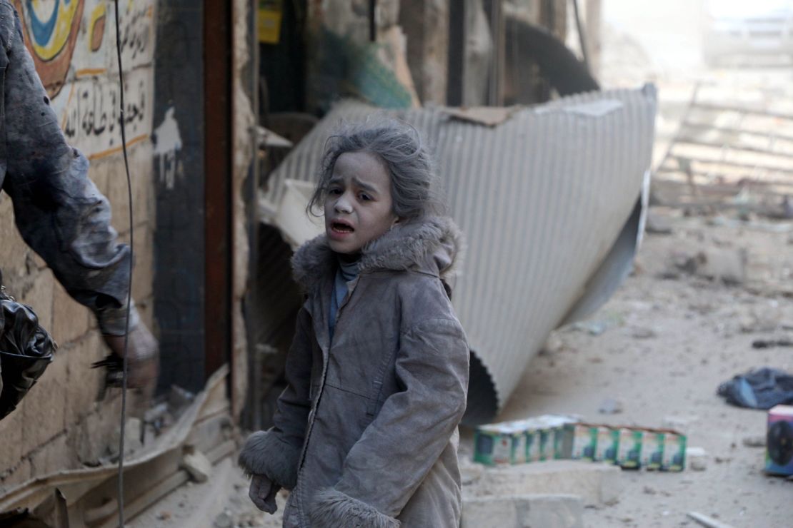 A Syrian girl after airstrikes hit the al-Shear neighborhood in Aleppo on Monday.