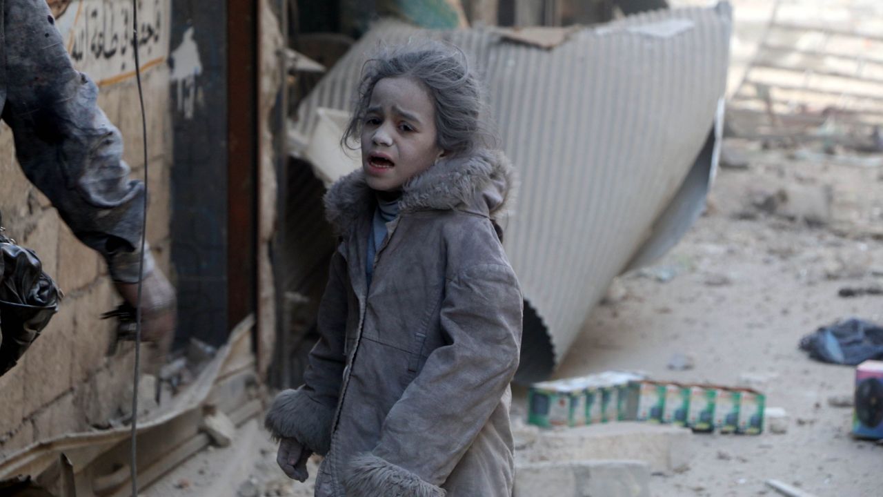 A Syrian girl after airstrikes hit the al-Shear neighborhood in Aleppo on Monday.