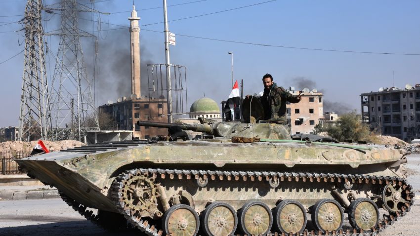 A member of Syrian pro-government forces drives a tank in the Haydariya northeastern neighbourhood in Aleppo on November 28, 2016, after they took control of the area from rebel fighters as part of their assault to retake the entire northern city. 
In a major breakthrough in the push to retake the whole city, regime forces captured six rebel-held districts of eastern Aleppo over the weekend, including Masaken Hanano, the biggest of those in eastern Aleppo. The army captured the Sakhur, Haydariya and Sheikh Khodr neighbourhoods on November 28, 2016 while Kurdish forces took the Sheikh Fares district from rebels, the Syrian Observatory for Human Rights said.
 / AFP / GEORGE OURFALIAN        (Photo credit should read GEORGE OURFALIAN/AFP/Getty Images)