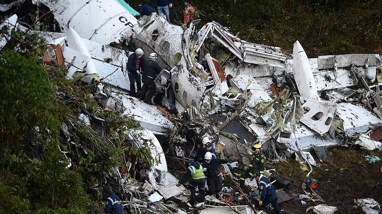 Rescuers search the wreckage of the charter plane Tuesday in mountains outside Medellin, Columbia.
