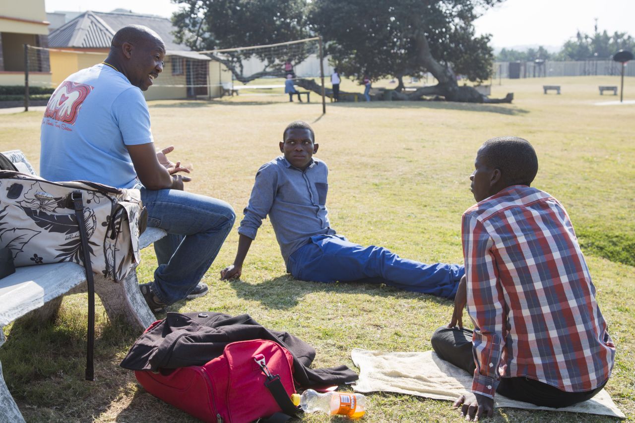 At the Mercury Hibberdene Childrens Camp, teenagers visit once a year from an HIV clinic visit once a year. Sabelo Chonco, center, and Nhlanhla Phewa talk with camp leader Tshepo Tshipe.
