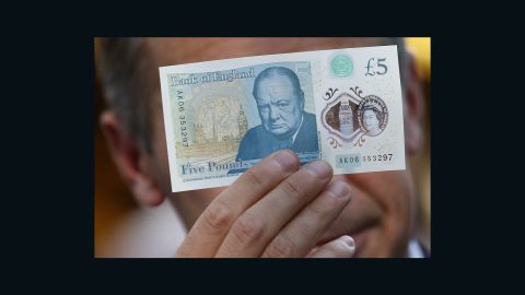 Mark Carney, governor of the Bank of England, poses with a new polymer five-pound note