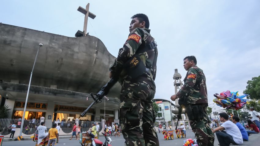 Military personnel stand guard in front of a church in Davao City, in the southern island of Mindanao on September 4, 2016, two days after a bomb explosion at a night market that left 14 people dead and 60 wounded.
Philippines police September 4 were searching for three people wanted for questioning over the bombing of a night market in President Rodrigo Duterte's hometown blamed on an Islamic militant group. / AFP / MANMAN DEJETO (Photo credit should read MANMAN DEJETO/AFP/Getty Images)
