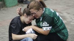 Fans of Brazil's soccer team Chapecoense mourn outside the Arena Conda stadium in Chapeco, Brazil, Tuesday, Nov. 29, 2016. A chartered plane that was carrying the Brazilian soccer team to the biggest match of its history crashed into a Colombian hillside and broke into pieces, Colombian officials said Tuesday. (AP Photo/Andre Penner)