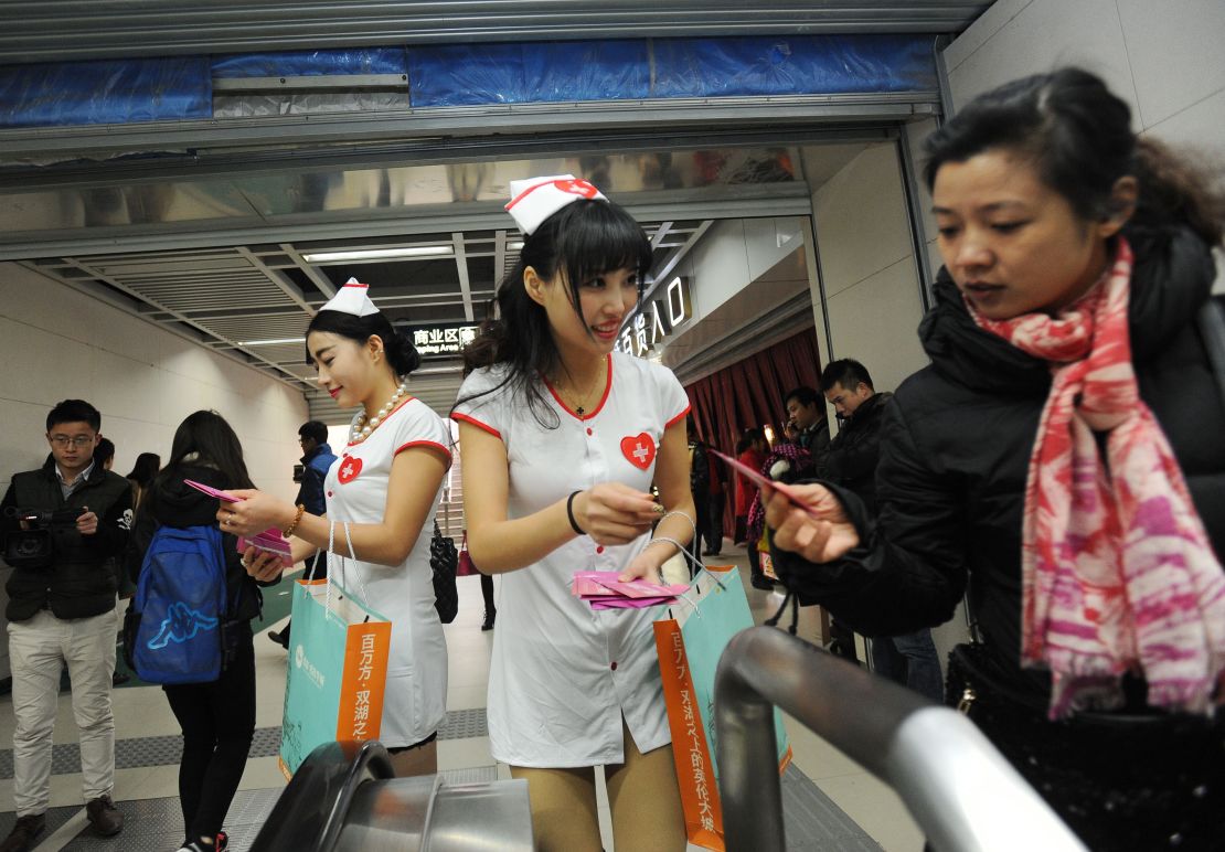 Volunteers hand out condoms in a subway station in Wuhan on World AIDS Day.