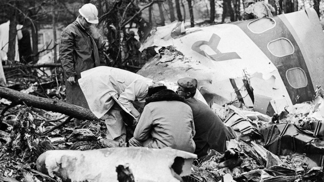 Rescue workers search the wreckage of a plane crash in Huntington, West Virginia. The plane carried the Marshall University football team and all passengers were killed.