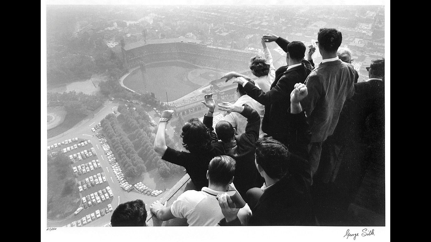 Baseball fans in Pittsburgh watch the World Series from a rooftop in 1960. George Silk was the photographer.
