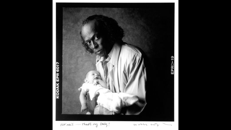 Jazz legend Miles Davis holds the grandchild of photographer William Coupon in 1986. "That's my baby!" Coupon wrote in his inscription to Leifer.