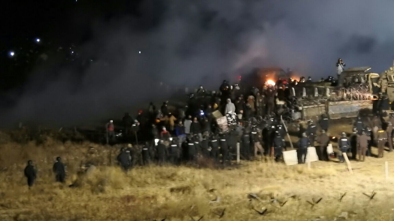 In this image provided by the Morton County Sheriff's Department, law enforcement and protesters clash near the pipeline site on Sunday, November 20.