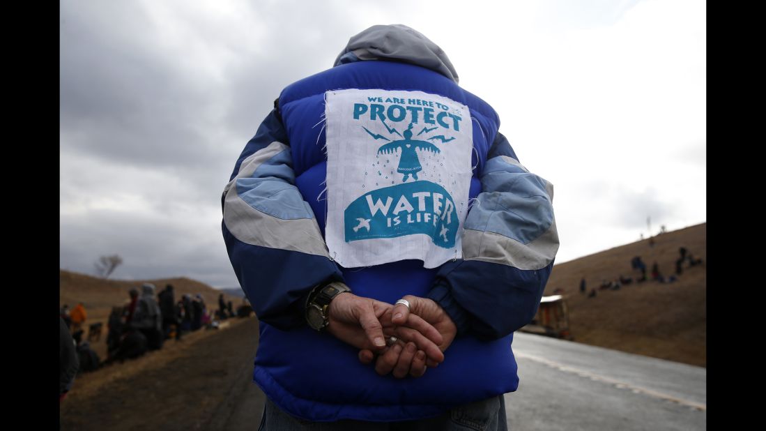 A man stands along Highway 1806 on November 24.