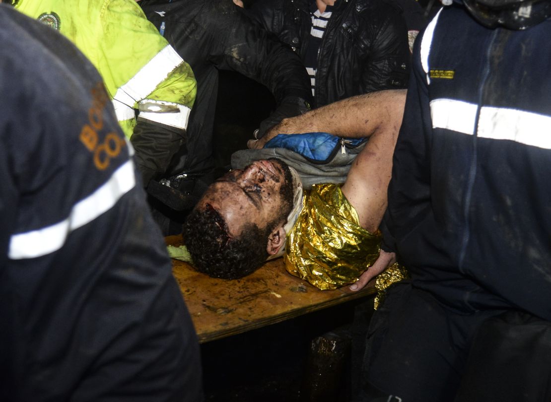 Survivor Helio Neto is helped by paramedics after being rescued from the plane's wreckage Tuesday.