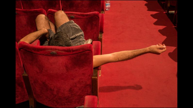 A director waits for the actors to arrive to begin rehearsals for a play in this theater. 