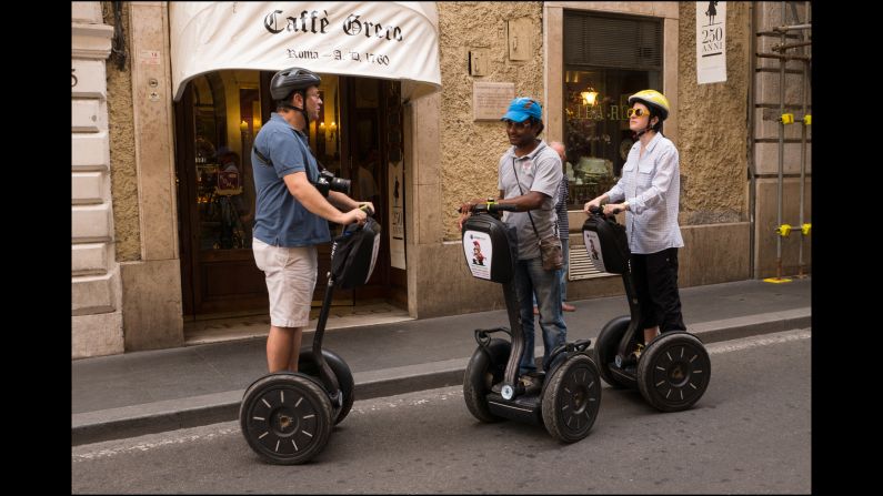 Tourists shop on the Via Condotti on their rented Segways.