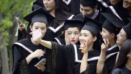 Female Chinese graduates dressed in academic gowns take a selfie during a graduation photo shoot at Beijing Film Academy in Beijing, China, 23 May 2016.

About 7.65 million college graduates will pour into China's job market in 2016 as the country's economy continues to slow. In contrast with the record high number of graduates, the number of available jobs shrunk by 4.5 percent year-on-year in the first quarter in 2016. Despite facing the most difficult employment environment in recent memory, more than 50 percent of college graduates consider this year's employment situation to be "acceptable," China News Service reported. According to Women of China, more and more Chinese graduates are considering setting up their own business upon graduation, with 77.2 percent showing an interest in entrepreneurship.