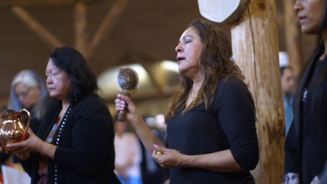 Grandmothers Florence Paynter, left, and Mary Maytwayashing offer prayers and song during a water ceremony.