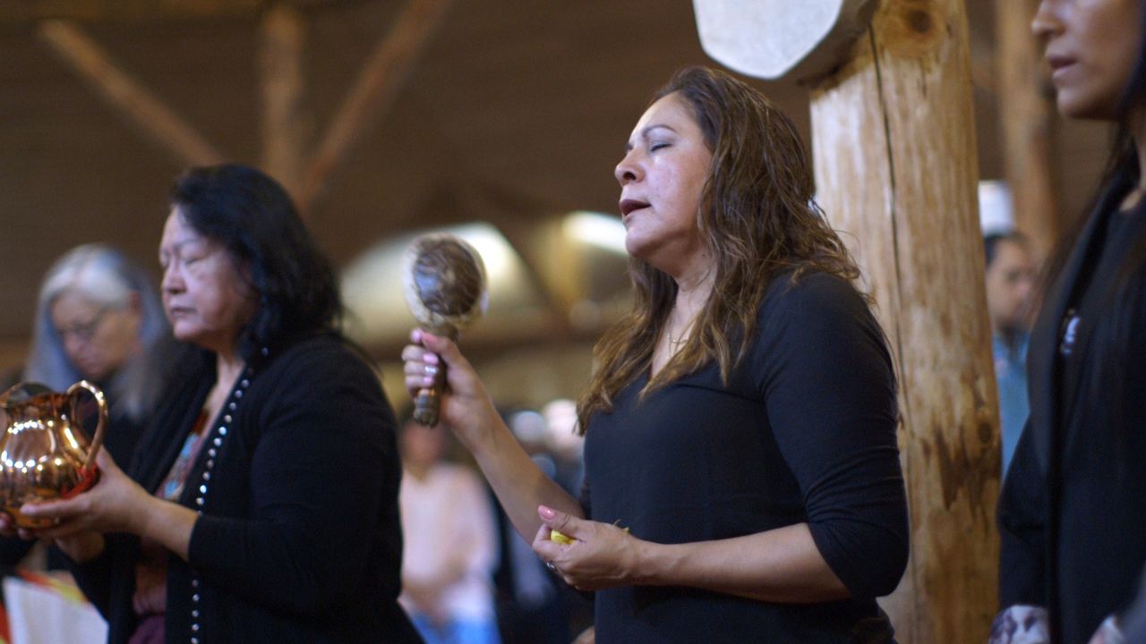 Grandmothers Florence Paynter, left, and Mary Maytwayashing offer prayers and song during a water ceremony.