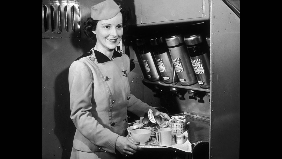 "You worked harder physically in those days," Nash recalls. "We served this big meal tray." <br />Pictured: A Canadian Colonial Airways flight attendant serves food and refreshments in the 1940s. 