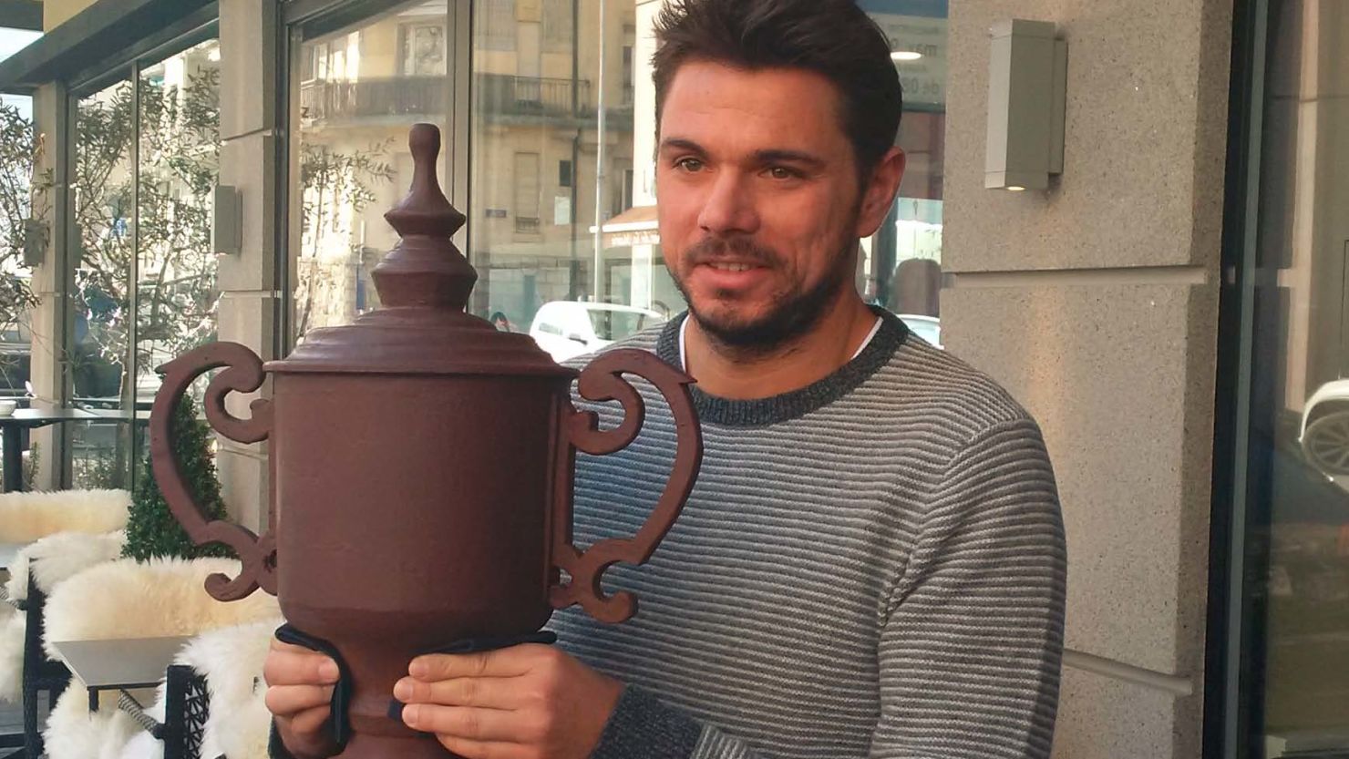 Stan Wawrinka holds the US Open chocolate replica gifted to him at the launch of the 2017 Geneva Open.