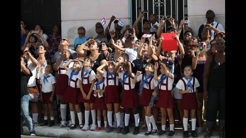 Schoolchildren react as a helicopter passes overhead in Cardenas, Cuba, on November 30.