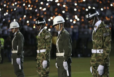 Soldiers and police attend the tribute in Medellin on November 30.