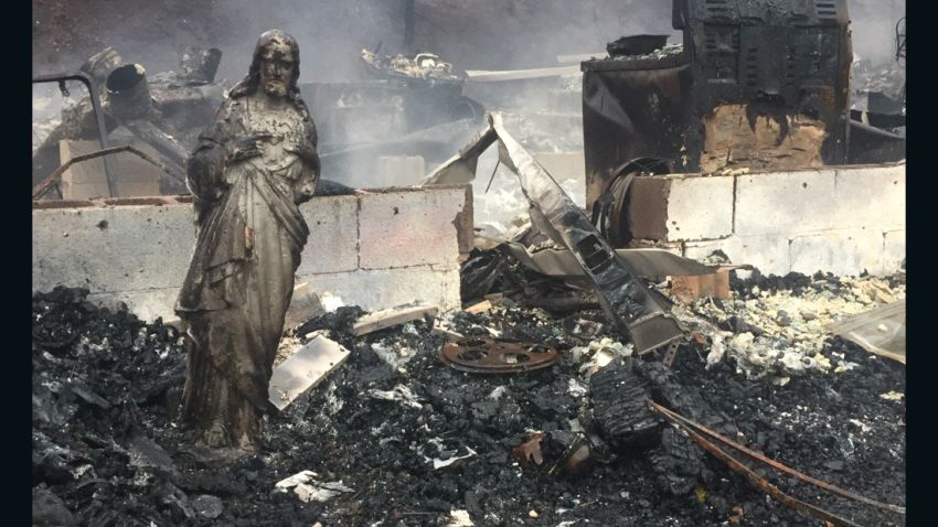 A statue of Jesus was the only thing left standing after the wildfires swept through this house in Sevier County, Tennessee.