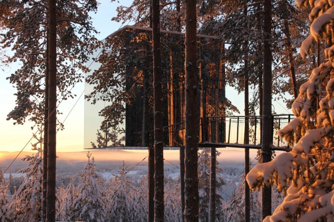 The mirrored walls of this Treehotel were designed to reflect the pristine surroundings. The base consists of an aluminum frame around the tree trunk and the interior is made from plywood with a birch surface. 