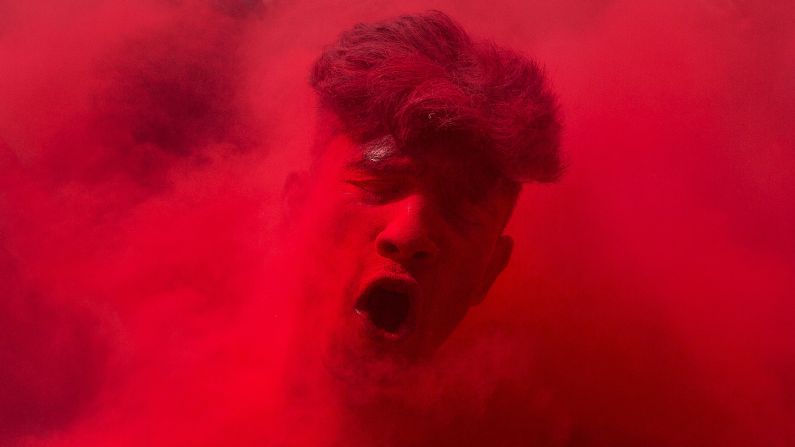 <strong>March 24:</strong> A reveler's face is smeared with colored powder as he dances during Holi celebrations in Gauhati, India. The Holi festival of colors is a Hindu celebration marking the arrival of spring.