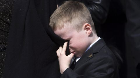 <strong>March 30: </strong>Doug Ford cries into his mother's coat as he watches the casket of his father, former Toronto Mayor Rob Ford, being placed into a hearse. Rob Ford <a href="http://www.cnn.com/2016/03/22/us/rob-ford-dies/" target="_blank">died of cancer</a> at the age of 46.