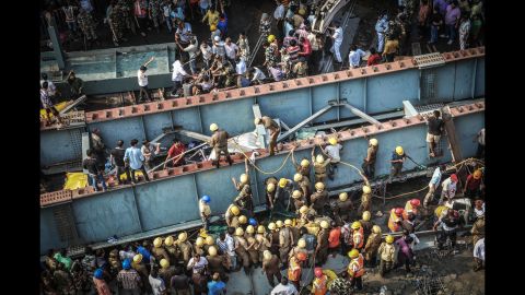 <strong>March 31: </strong>Rescue workers and volunteers try to free people trapped under a collapsed overpass in Kolkata, India. More than a dozen people were killed and many more were missing after the overpass, which was under construction, collapsed in a congested area of the city.