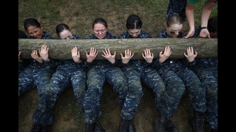<strong>May 17:</strong> Plebes from the US Naval Academy perform situps with a 12-foot log on top of them during the annual Sea Trials training exercise.