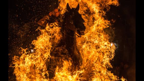 <strong>January 16:</strong> A horseman jumps over a bonfire during the annual Las Luminarias festival in San Bartolome de Pinares, Spain. In honor of Anthony the Abbot, the patron saint of animals, horses are traditionally ridden through bonfires to purify and protect them in the year ahead.