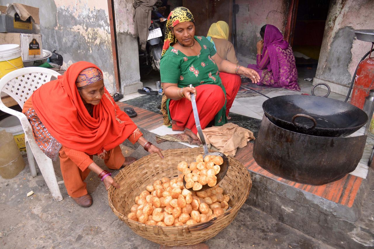 An Indian woman cooks 'golgappa,' also known as pani puri.
