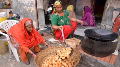 An Indian woman cooks 'golgappa,' also known as pani puri.