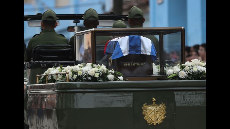 The trailer of a military jeep carries the flag-draped coffin containing Castro's ashes.