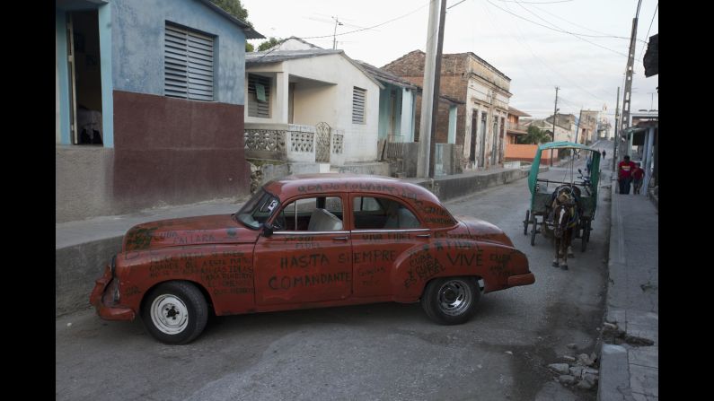 A car adorned with messages to Castro sits parked on a street in La Esperanza, Cuba, on Wednesday, November 30.