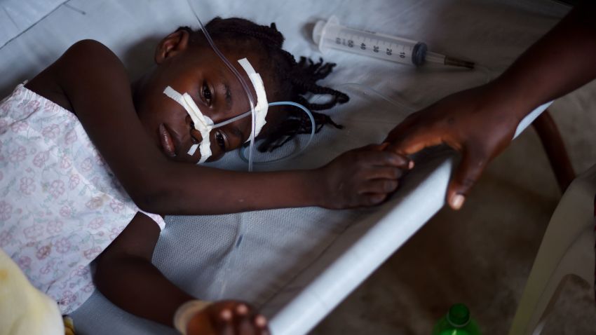 A young girl, with cholera symptoms is treated at the Cholera Treatment Center of Diquini in Port-au-Prince, Haiti on 23 August, 2016. 
The cholera epidemic that started in 2010 has infected some 800,000 and killed nearly 10,000 people.  / AFP / HECTOR RETAMAL        (Photo credit should read HECTOR RETAMAL/AFP/Getty Images)