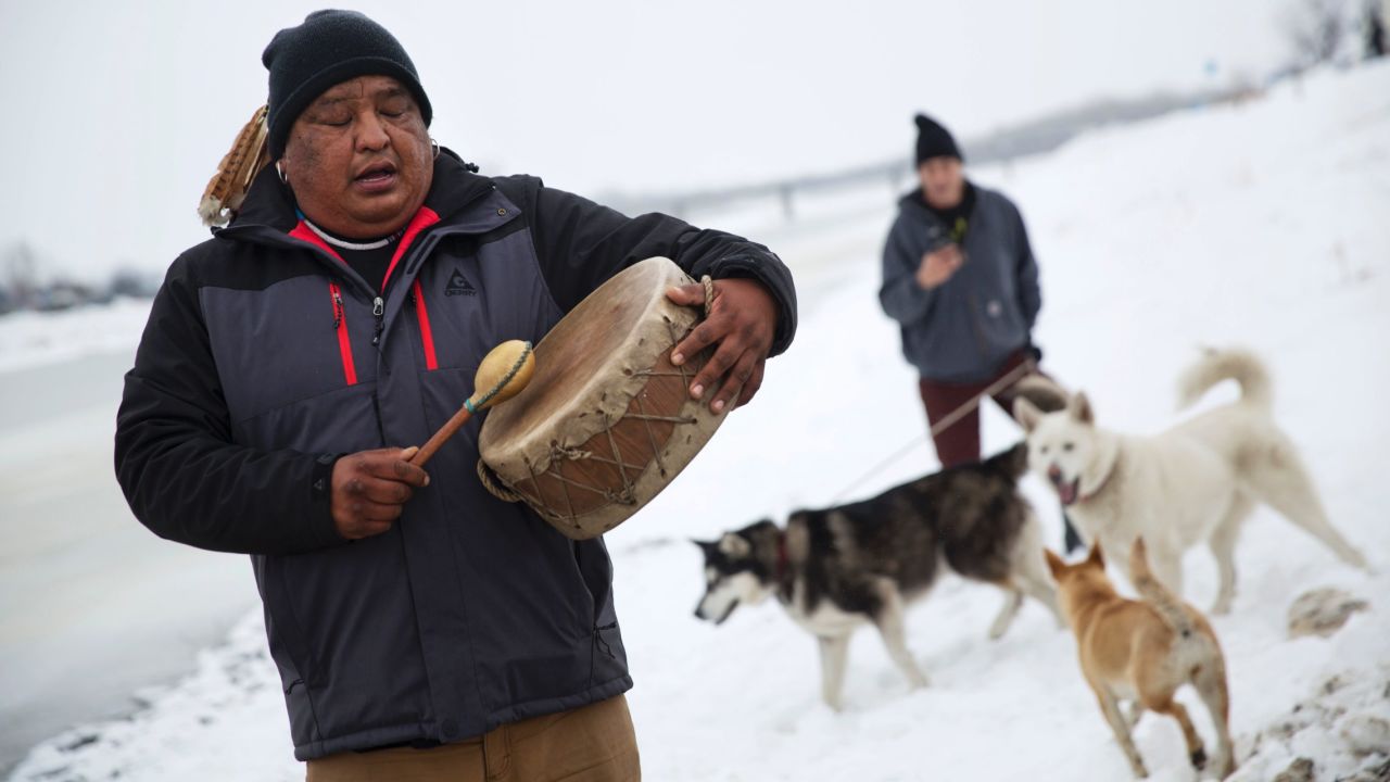 Dan Nanamkin of the Colville Nez Perce tribe drums a traditional song by the Cannonball River in Cannon Ball, North Dakota, on Thursday, December 1. 