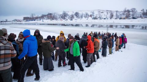 A procession makes its way down to the Cannonball River to take part in a Native American water ceremony on December 1.