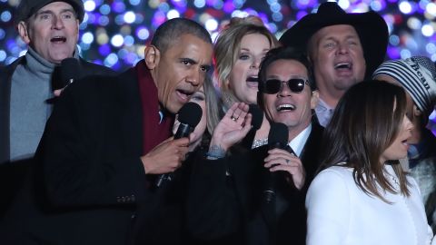 WASHINGTON, DC - DECEMBER 01: U.S. President Barack Obama sings Jingle Bells with Marc Anthony (C), James Taylor (L), Trisha Yearwood, Garth Brooks (R) and Eva Longoria (R, foreground) during the National Christmas Tree lighting ceremony, on December 1, 2016 in Washington, DC. This year is the 94th annual National Christmas Tree Lighting Ceremony. (Photo by Mark Wilson/Getty Images)
