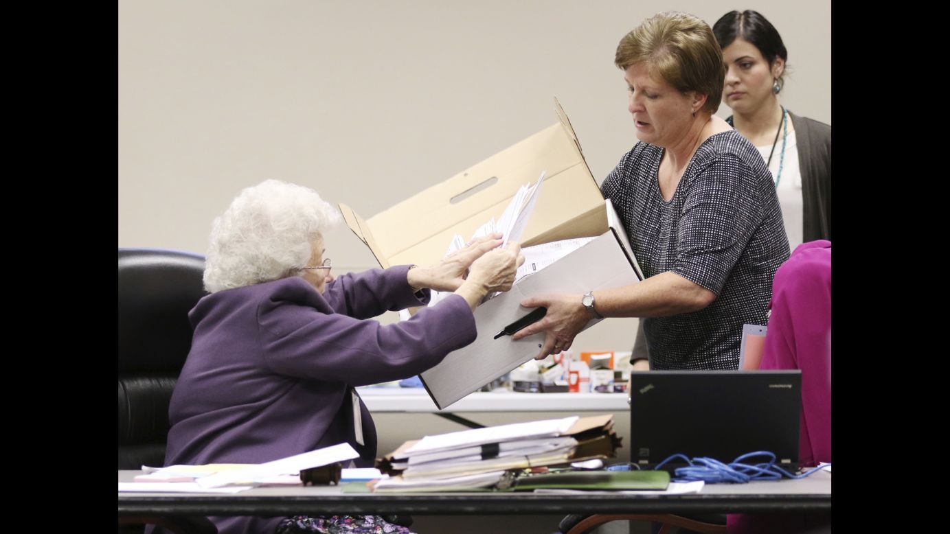 County Clerk Brenda Jaszewski holds a box of absentee ballots from the town of Erin, Wisconsin, as Board of Canvass member Marilyn Merten reaches to take a ballot out during a <a href="http://www.cnn.com/2016/11/25/politics/green-party-recount-wisconsin/" target="_blank">statewide presidential election recount</a> Thursday, December 1, in West Bend, Wisconsin.