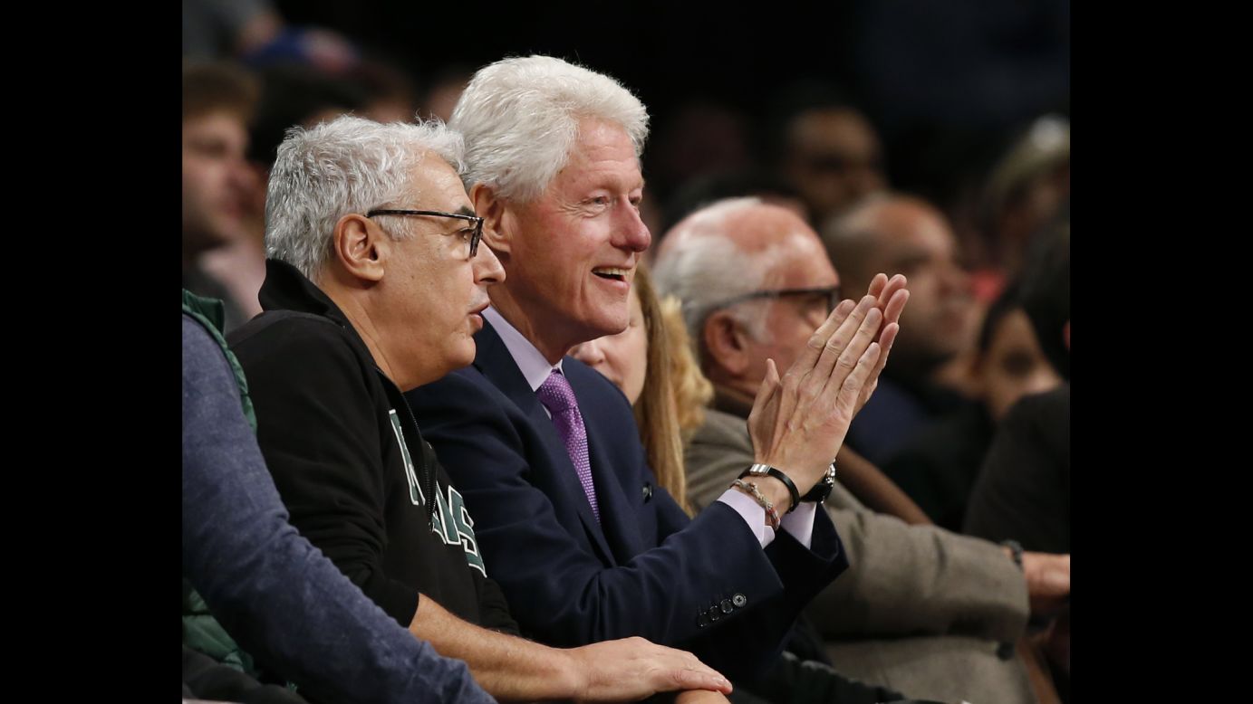 Milwaukee Bucks owner Marc Lasry, left, sits beside former President Bill Clinton, as the pair watch an NBA basketball game between the Brooklyn Nets and the Milwaukee Bucks, Thursday, December 1, in New York.