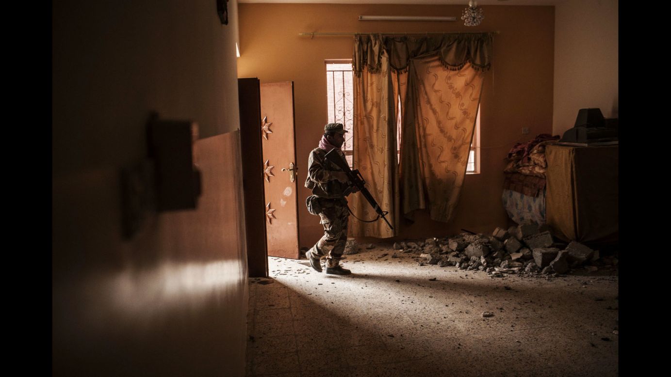 An Iraqi soldier searches a home for ISIS militants after Iraqi forces retook the village of Al-Qasr on Wednesday, November 30.