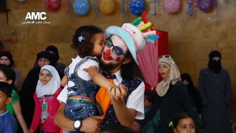 A little girl gives Anas al-Basha a kiss on the cheek during Eid celebrations in July 2015.