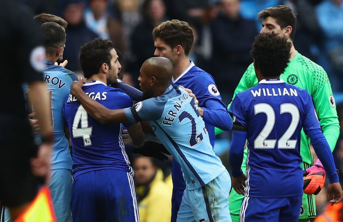 Fernandinho grabs Cesc Fabregas in the clashes in stoppage time. The Manchester City player was red carded in the incident.